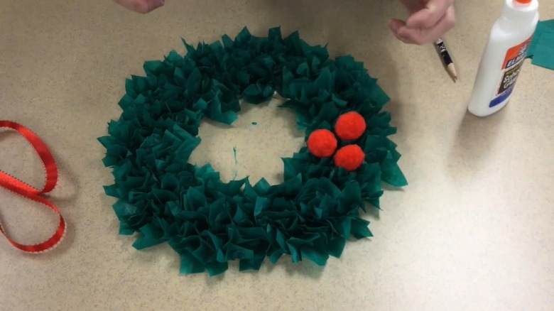 Green and red wreath mad from tissue paper