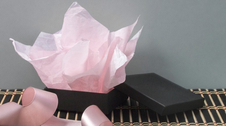 Pink tissue paper in black gift box