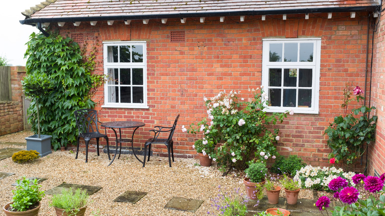 An English garden along the side of a brick house