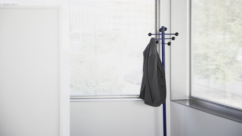 jacket hanging from a corner coatrack