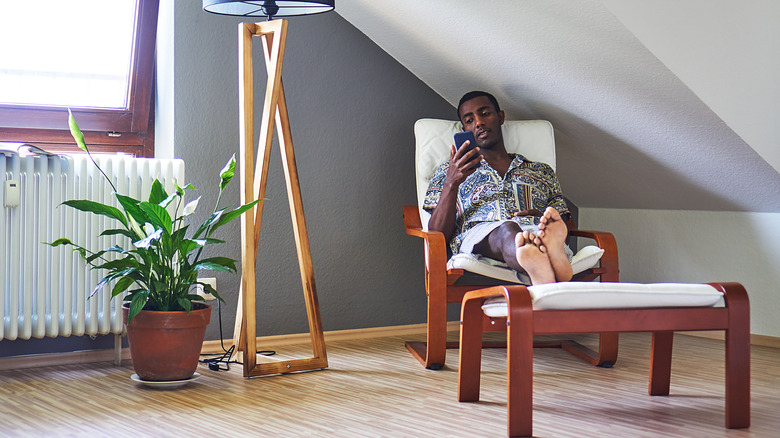 Man in a room with a peace lily