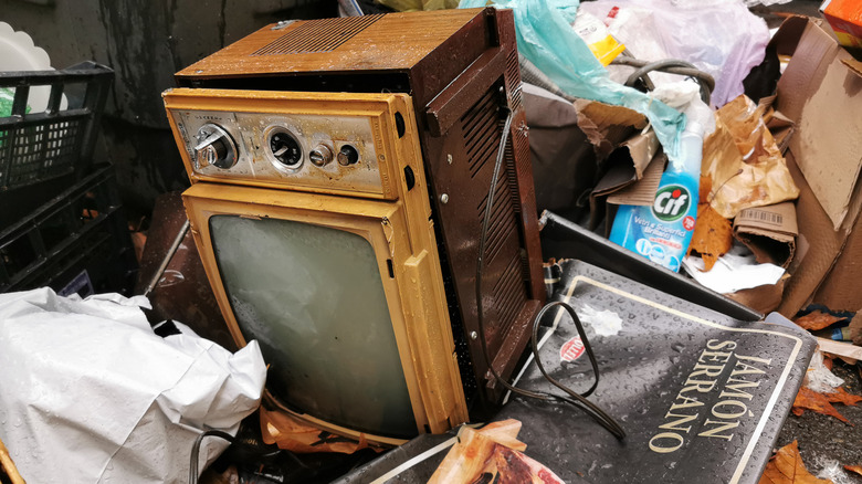 an antique Westinghouse television in the garbage