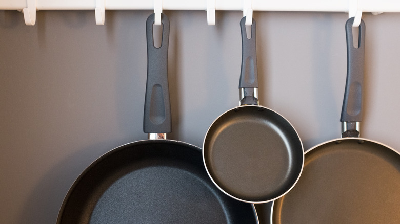 pots pans hanging on rack