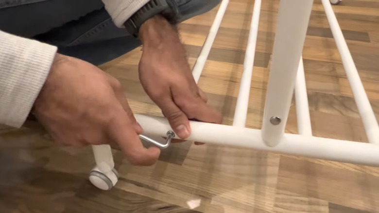 Person assembling IKEA rack