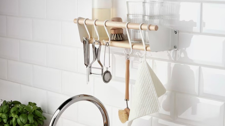 Birch and metal wall shelf holding kitchen utensils