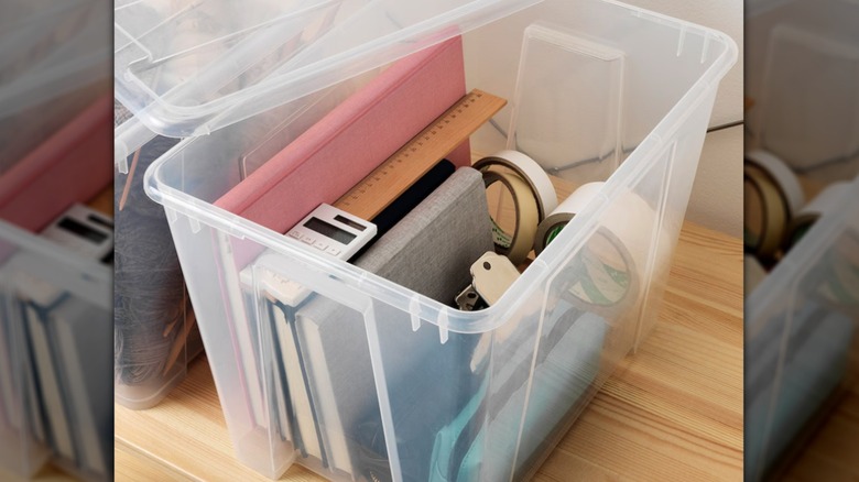 Transparent storage box holding school supplies