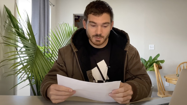 young man checking pest control contract