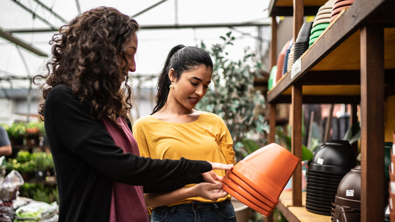 Two women shopping for pots