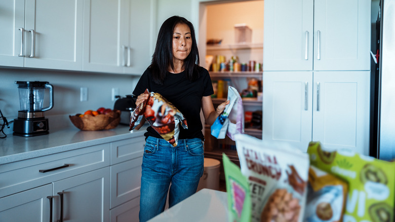 A woman sorting out food from the pantry