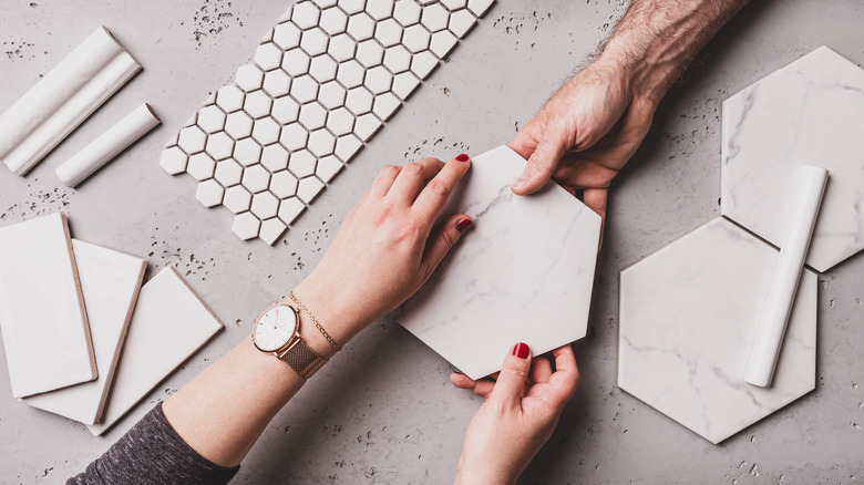 Hands holding tiles 