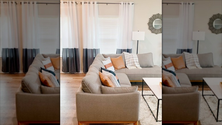 Living room with gray banded white curtains