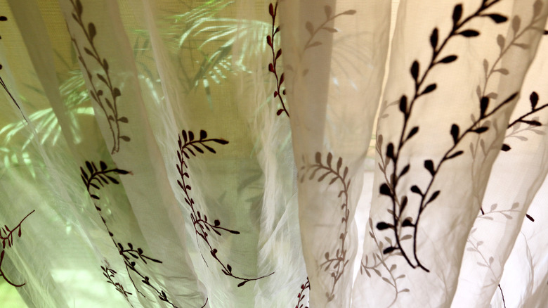 Beige linen curtain with embroidered stems