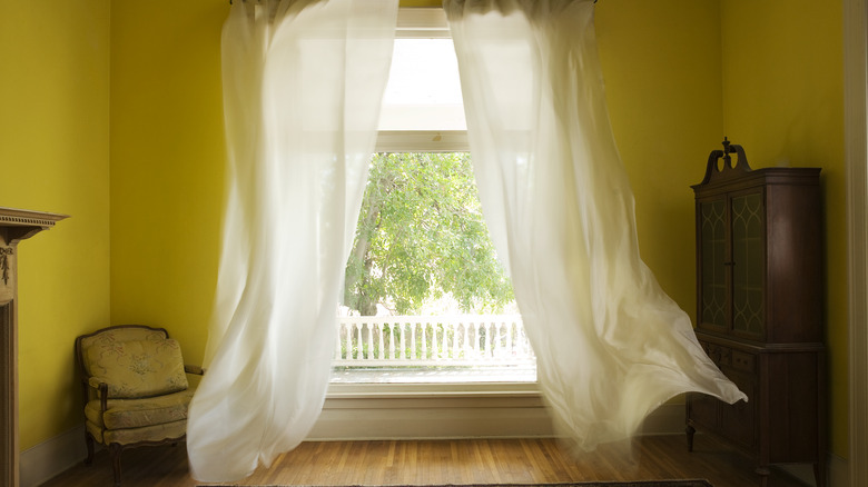 drapes over an open window