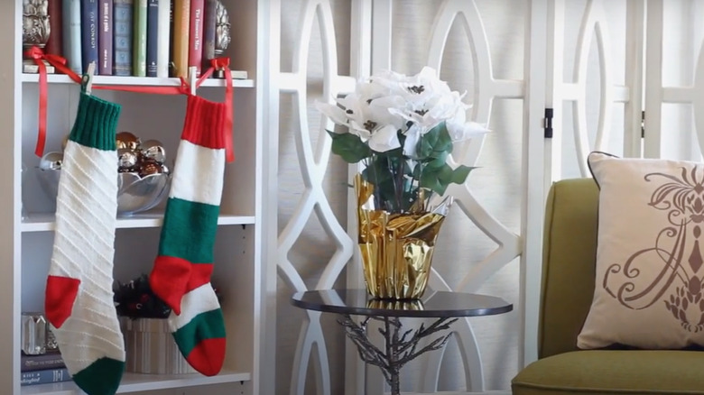 two stockings hanging from bookcase