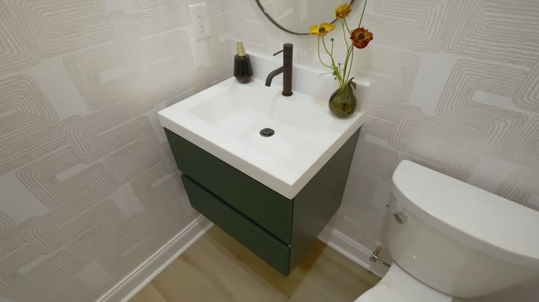 Green wall-hung vanity in bathroom