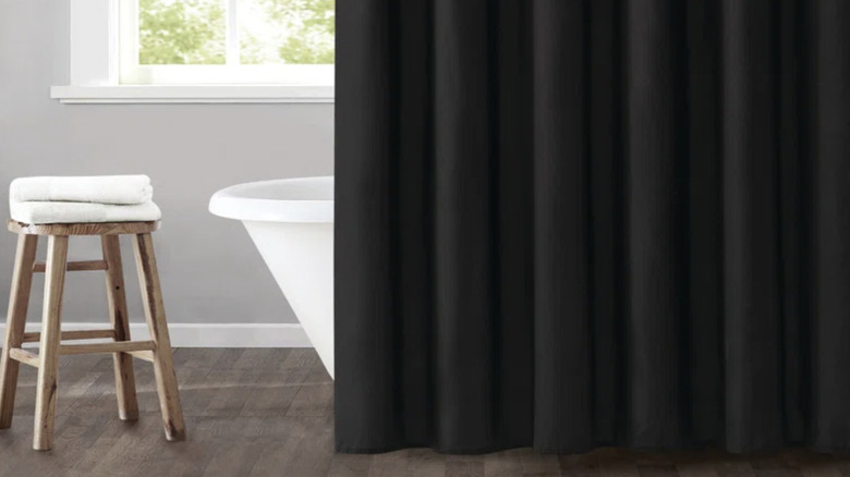 Gray bathroom with black shower curtain