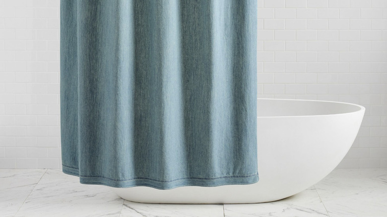 Light gray bathroom with denim blue shower curtain