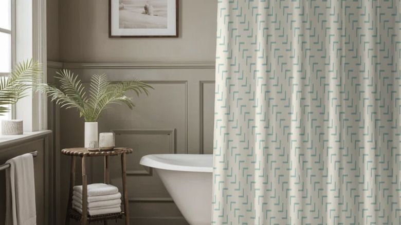 Gray bathroom with green patterned shower curtain