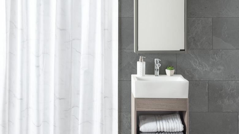 Gray bathroom with white shower curtain