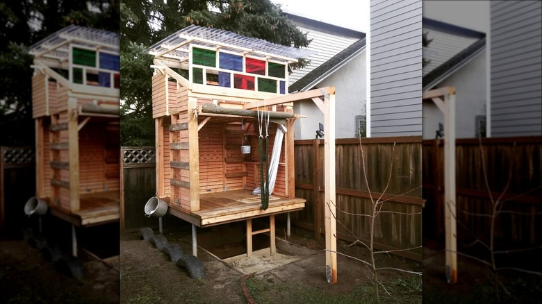 wood play house with colored windows