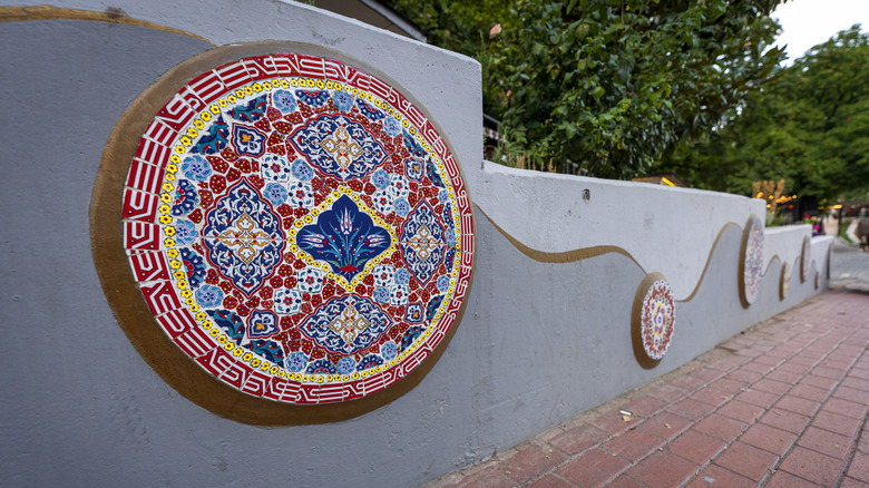 Red, blue, and yellow round mosaic on exterior wall