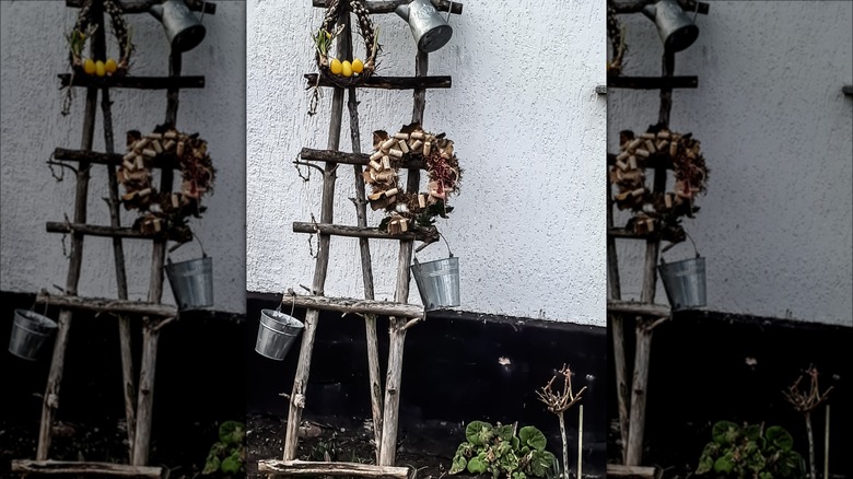 Outdoor ladder with decor items hanging on it