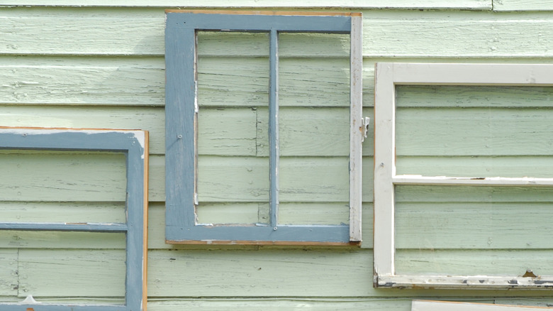 Old white and blue mirrors on exterior wall