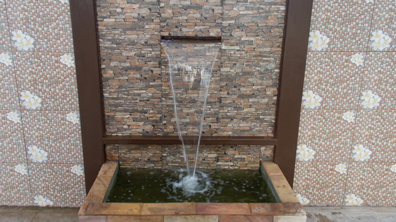 Stone fountain on exterior wall