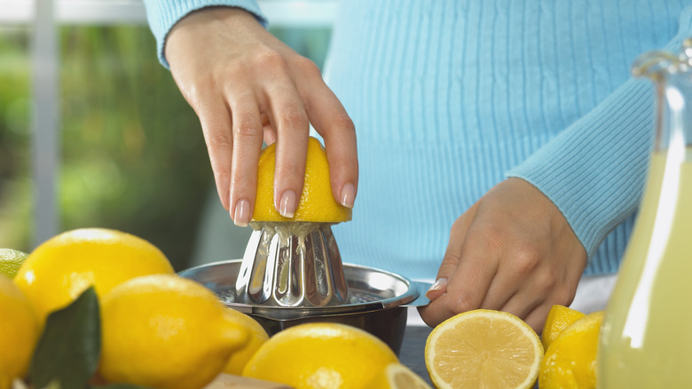 A woman juicing lemons 