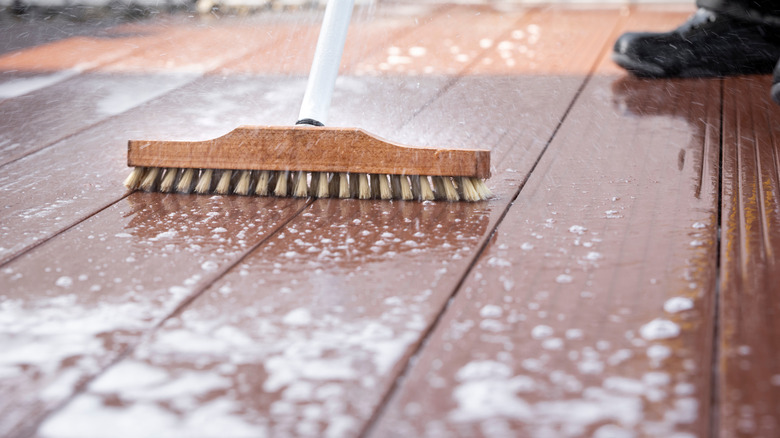 scrubbing deck with large brush