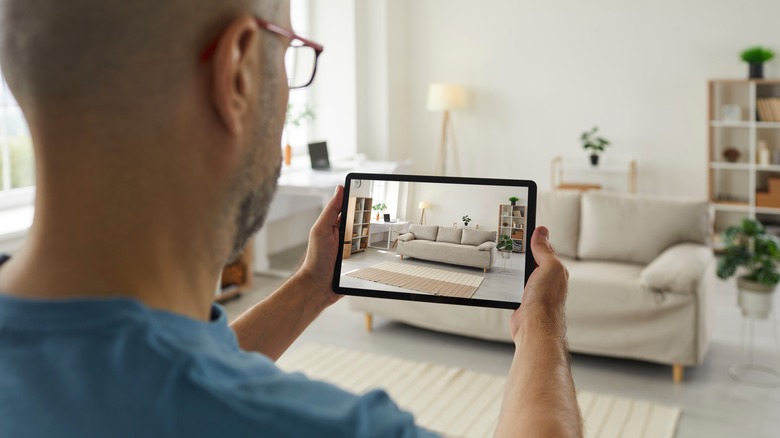 man taking picture of couch