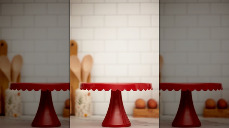 A red cake stand sitting in the kitchen