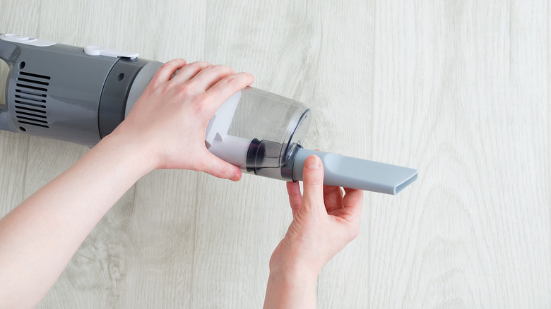 putting a crevice tool on a vacuum