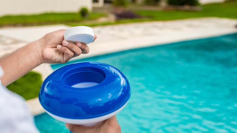 person holding a chlorine dispenser