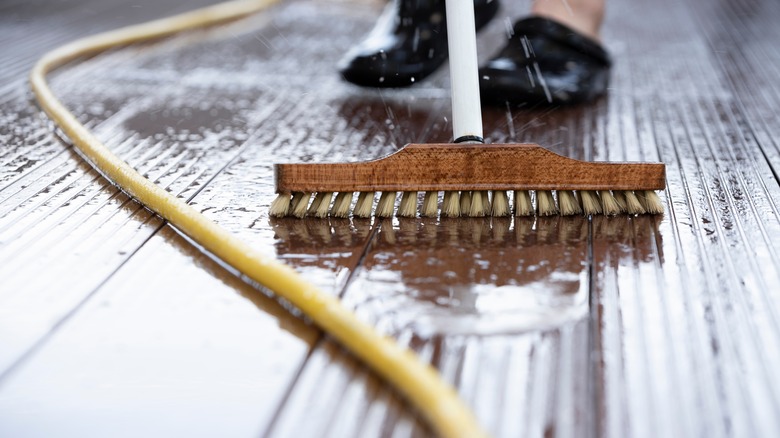 a person scrubbing a deck