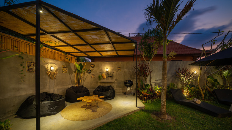 Tropical patio with wall sconces