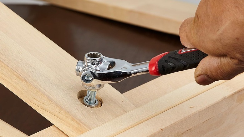 A hand tightening bolt with a dog bone wrench.