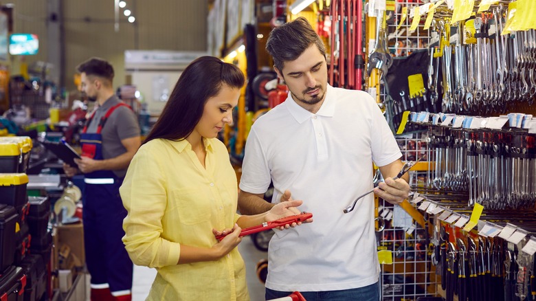 People shopping for various types of wrenches.