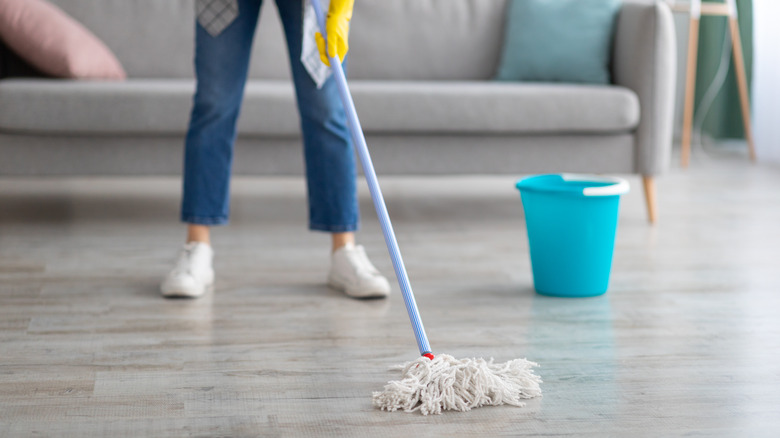 woman mopping living room floor