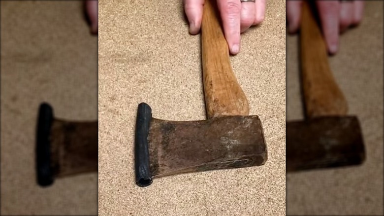 Garden hose piece on end of an axe as a protector