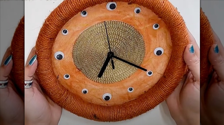 Creative wall art clock made with an old garden hose