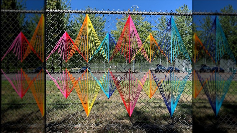 Colorful mural design made on a chain link fence