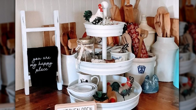 Tiered tray on counter with measuring cups and crocks