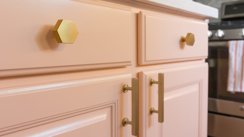 Gold cabinet pulls on pink kitchen cabinets