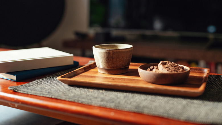 Coffee table with tray, books, and dishes