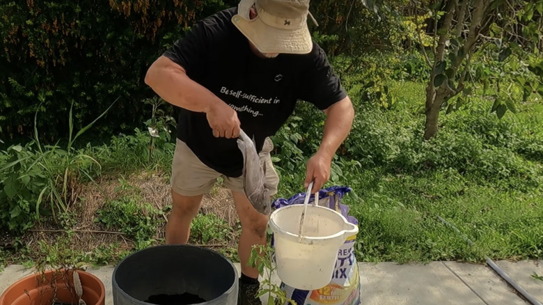 gardener lifting fish bucket