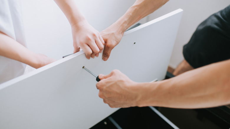 Couple assembling IKEA furniture