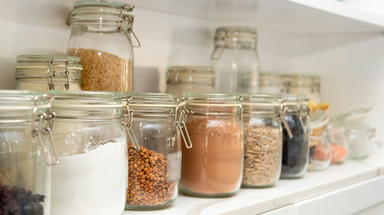 Ingredients and seasonings in jars on a pantry shelf