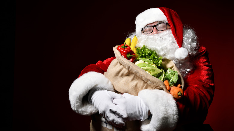 Santa holding produce