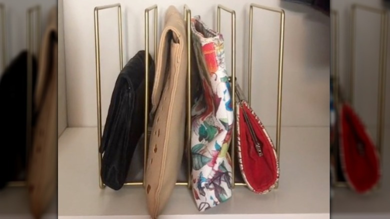 Gold file holder filled with clutches and small bags